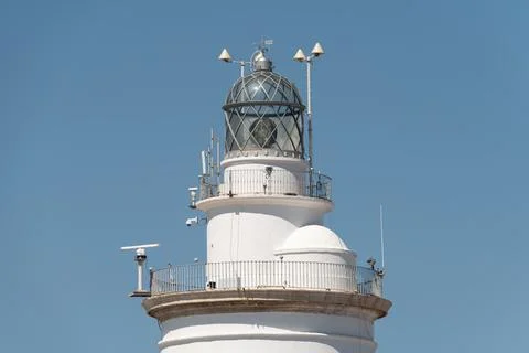 Upper section of La Farola lighthouse with lantern room and railings. Malag.. Stock Photos