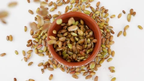 Upper shot of falling beans seeds in a mud glass Video stock 159638141