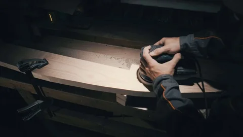 Upper vier, joiner hands use circular grinder on pine wood to reveal structure,  스톡 동영상 78438084