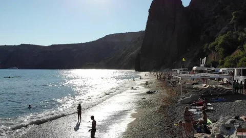Upper view beach washed by waves reflecting sunlight Video stock 103181872