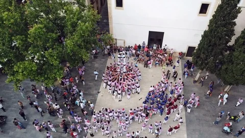Upper view castellers climb down from human castle on square Video stock 103286784