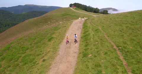 Upper view of couple riding bikes in the pyrenees Stock Footage 65511181