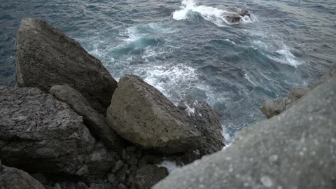 Upper view deep blue sea waves crash on coastal rocks Video stock 102664670