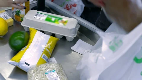 Upper view food on conveyor and plastic bag at cashier desk Video stock 100247956