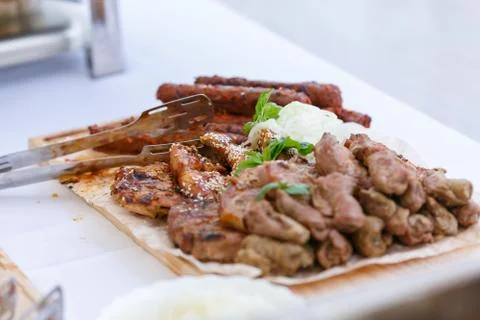 An upper view of fresh assorted barbeque on the wooden cutting board Stock Photos
