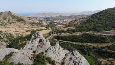 Upper view hills and roads in valley with town on horizon Video stock 103181271