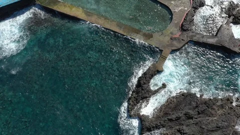 Upper view huge ocean waves roll on hotel pool barrier Stock Footage 101963646