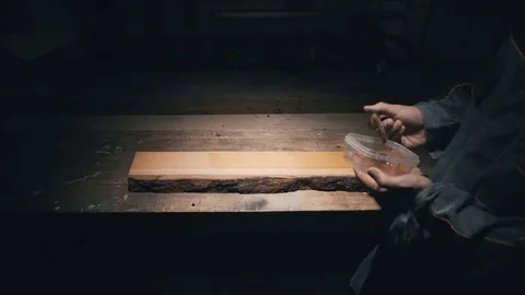 Upper view, joiner work desk, woodworker using a brush causes the layer of oil,  스톡 동영상 78709717