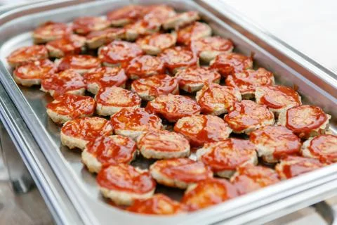 An upper view on the metal container full of hamburger patties Stock Photos