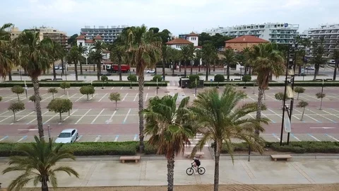 Upper view palms man rides bike on track against parking lot Stock Footage 103298894