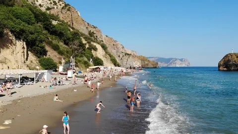 Upper view people rest on beach with terraces and tents Video stock 103182277