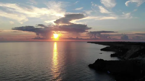 Upper view sun sets reflecting light on sea near coastline Video stock 103182742