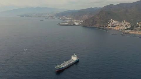 Upper view tanker in calm harbor at resort and mountains Stock Footage 102052026