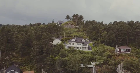 Upper view white house on rocky coast with boats at piers Stock Footage 101377279