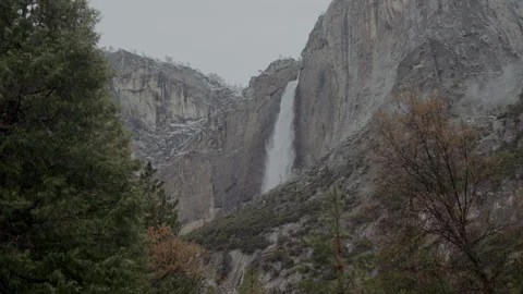 Upper Yosemite Fall with light snow on granite cliffs Video stock 347986869