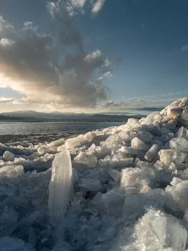 Upright ice stacks in vertical image at Vineyard Beach on Utah Lake in Utah.. Stock Photos
