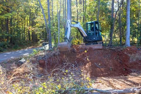 Uprooting trees and preparing land for construction is done with a tractor Stock Photos