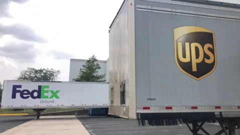UPS And Fedex Cargo Trailers parked at Loading Dock Stock Footage 244071728