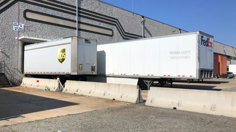 Ups And Fedex Trailers Backed into Loading Dock Stock Footage 239038914