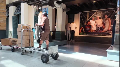 UPS driver making delivery in Valencia Town Center at Torrid department store Stock Footage 277235818