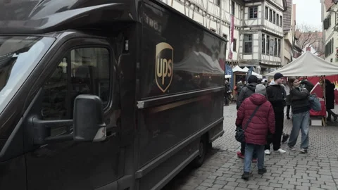 UPS truck driving through small city streets of Tuebingen Germany 4k Stock Footage 299869888