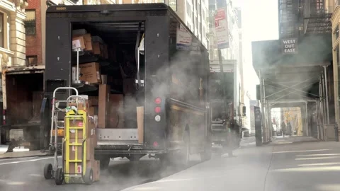 UPS worker watching guarding packages boxes mail delivery truck parked on street Stockbeeldmateriaal 149806368