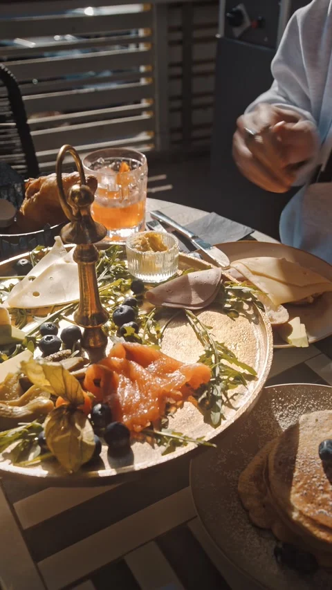 Upscale Breakfast Spread with Drinks and Fresh Food Items Stock Footage 334602770