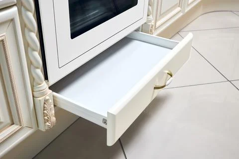 Upscale classic kitchen drawer for plates or dishes shelf cabinet. Selective Stock Photos