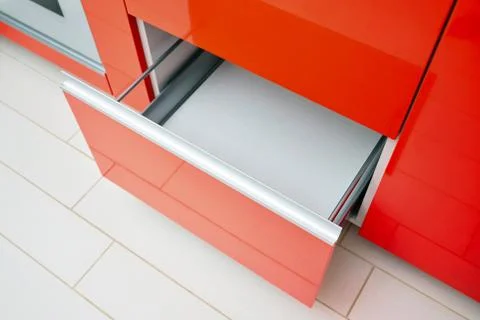 Upscale Maple Red kitchen drawer for plates or dishes shelf cabinet. Pull out Stock Photos