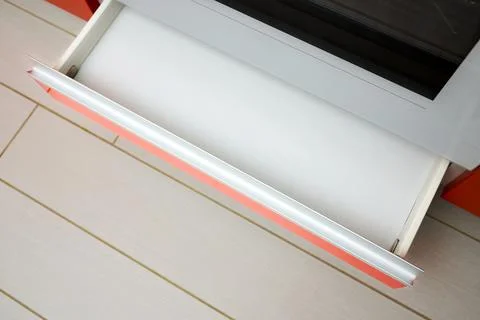 Upscale Maple Red kitchen drawer for plates or dishes shelf cabinet. Pull out Stock Photos