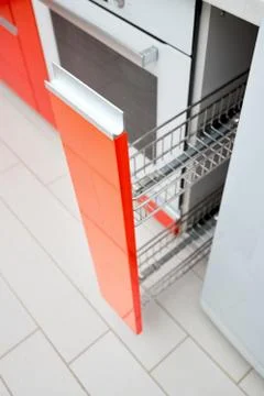 Upscale Maple Red kitchen spice rack drawer vertical cabinet. Pull out spice Stock Photos