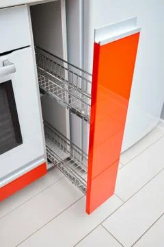 Upscale Maple Red kitchen spice rack drawer vertical cabinet. Pull out spice Stock Photos