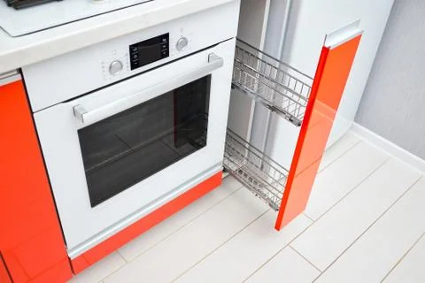 Upscale Maple Red kitchen spice rack drawer vertical cabinet. Pull out spice Stock Photos