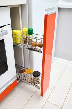 Upscale Maple Red kitchen spice rack drawer vertical cabinet with mill jars of Stock Photos