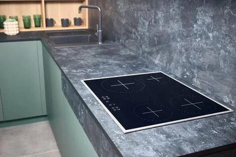 Upscale modern flat design loft kitchen with Induction electric cooker black Stock Photos