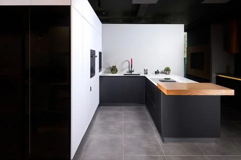 Upscale modern flat design loft kitchen with Induction cooker black glass h.. Stock Photos