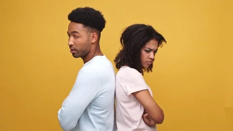 Upset african lovers standing back to back isolated Stock Footage