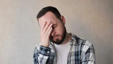 Upset and bearded man looking at camera. Closeup face of handsome guy with sad Stock Footage 237393684