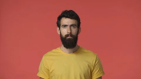 Upset and disappointed middle-eastern bearded man in yellow t-shirt feeling Stock Footage 115780492