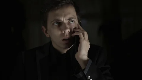 An upset and surprised young man having a bad conversation on the phone Stock Footage 120597494