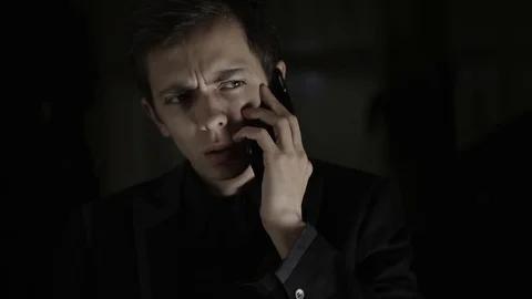 An upset and surprised young man having a bad conversation on the phone Stock Footage 120597602