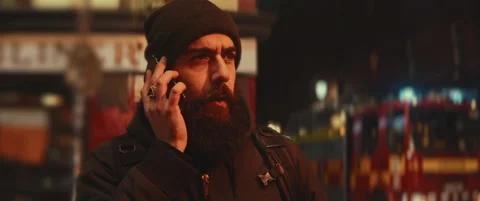 Upset bearded young man talking on the phone and fire truck lights Stock Footage 203583838