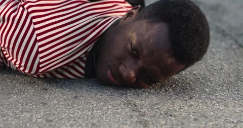 Upset black guy lying on ground during arrest Vídeos de archivo 155901371