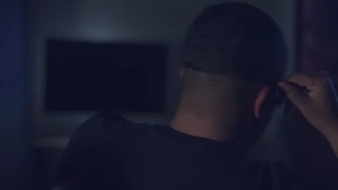 Upset boring mixed race man watching tv Stock Footage 87248176