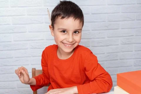 Upset boring schoolboy doing homework. Education, school, learning difficulti Stock Photos