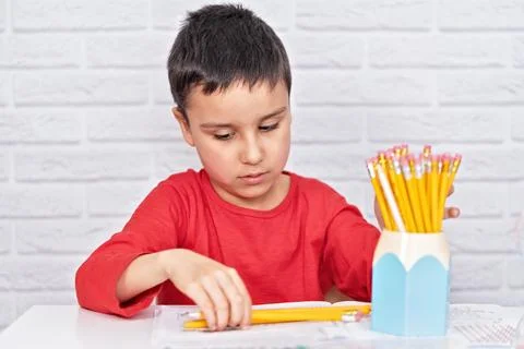 Upset boring schoolboy doing homework. Education, school, learning difficulties Stock Photos