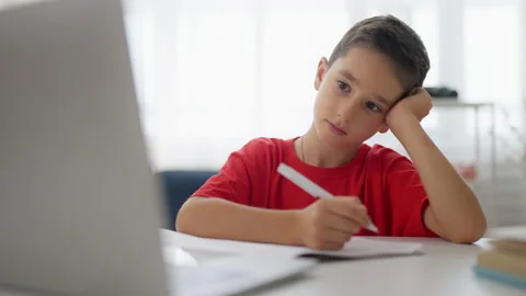 Upset boy having no motivation to do homework, difficult math problem, trouble Stock Footage 224957166