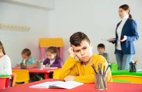 Upset boy in schoolroom Stock Photos