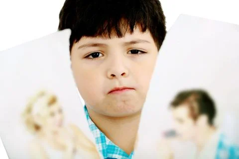 Upset boy standing in front pcture of parents with problems against white bac Stock Photos