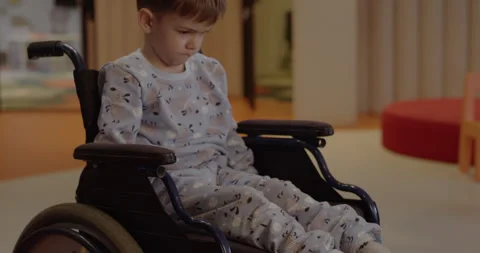 Upset boy in a wheelchair Stock Footage 283058342